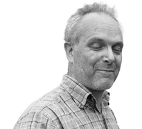 Image of managing director of innovative pool lift company with his eyes shut smiling.... He has short hair, stubble and is middle aged, friendly, approachable and attractive and relaxed looking.